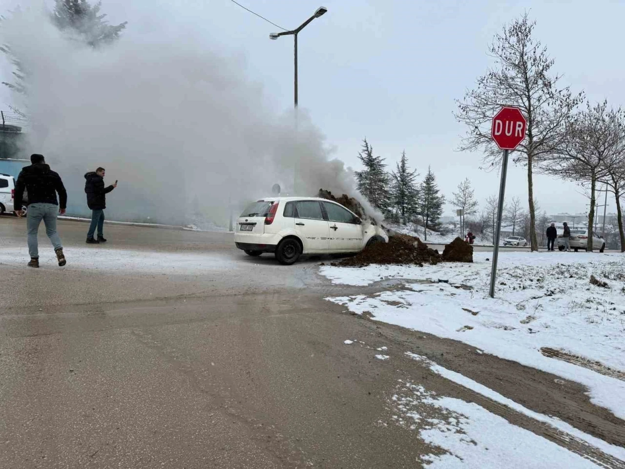 Ekskavatör toprak atarak yanan otomobili söndürdü
